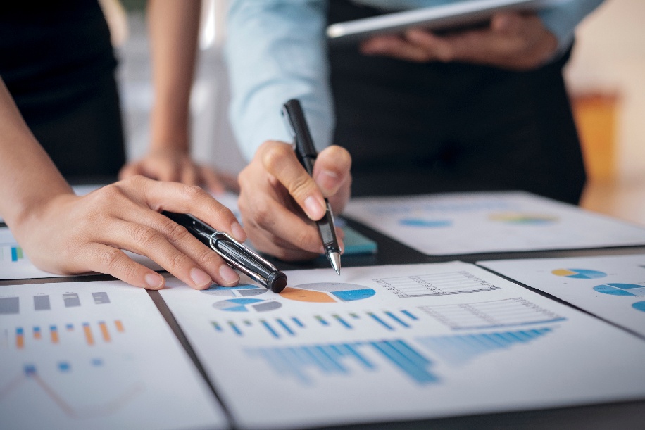 Equipo revisando gráficos y datos para valorar cuándo encargar una investigación social aplicada antes de diseñar una política o proyecto.